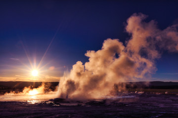 Clepsydra Geyser in the Lower geyser basin at Yellowstone National Park erupts almost continuously and looks spectacular at sunset at this park in Wyoming.