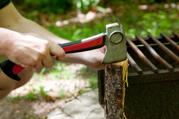 Hands with axe and wood