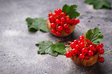 Ripe red currant berries in wooden bowls