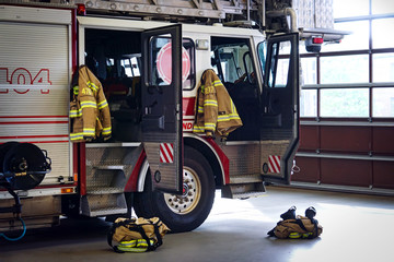 Firemen gear on firefighter truck in the fire station