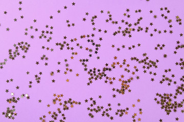 Fototapeta premium Pastel background decorated with shiny decorative stars and balls.