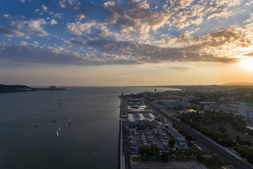 Aerial view of the Belém neighborhood in the city of Lisbon with sail boats on the Tagus River at sunset; Concept for travel in Portugal and visit Lisbon
