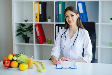 Health. Diet and Healthy. Nutrition. Portrait of a Dietitian's Doctor with Fresh Fruits and...