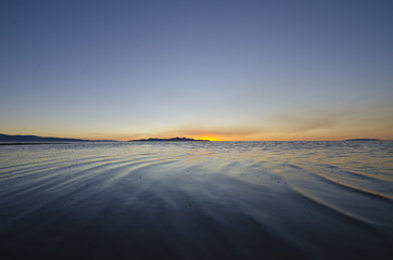 Fototapeta na wymiar The calm wavy water of the great salt lake evening sunset light. 