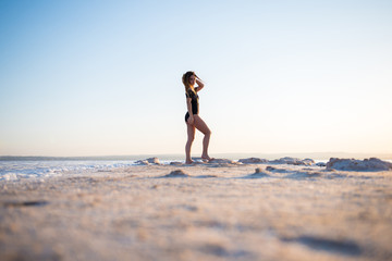 Pretty young girl in swimsuit at the beach