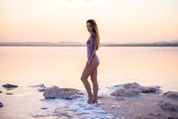 Fototapeta na wymiar Pretty young girl in swimsuit at the beach