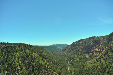 Beautiful overlook of an Arizona valley near Sedona, Arizona featuring luscious trees and rockfaces