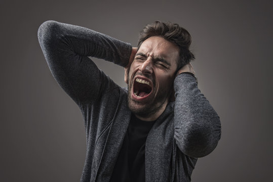Enraged troubled man screaming in anger, crazy and mental