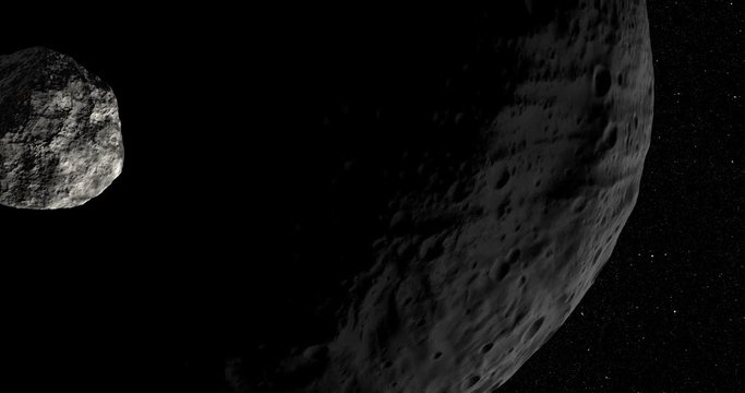 An asteroid tumbles slowly in space as it passes Vesta. Reversible, can be rotated 180 degrees. Elements of this image furnished by NASA.