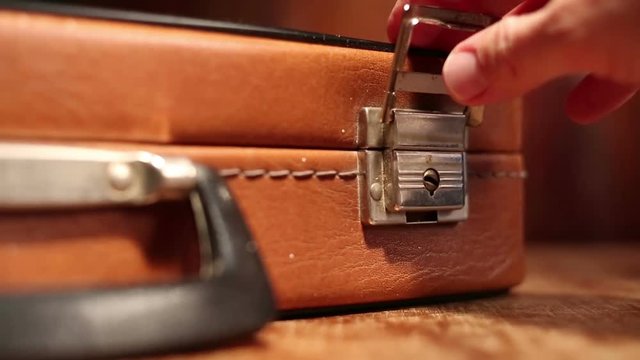 Close up on vintage brown suitcases lock.