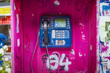 Poster Old magenta phone booth sprayed with graffiti in Thessaloniki, Greece, unused for a long time © Teodor Lazarev