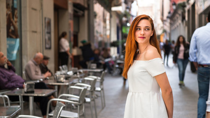 Fototapeta premium Portrair of young redhead pretty girl in the street