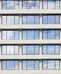 windows reflect the sky in sunny day