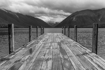 The jetty at Lake Rotoiti, Nelson Lakes National Park, New Zealand, with the lake and mountains in...