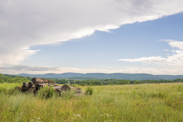 Summer landscape scenery featuring Vernon, New Jersey field on the foreground, mountains and cloudy sky on the background