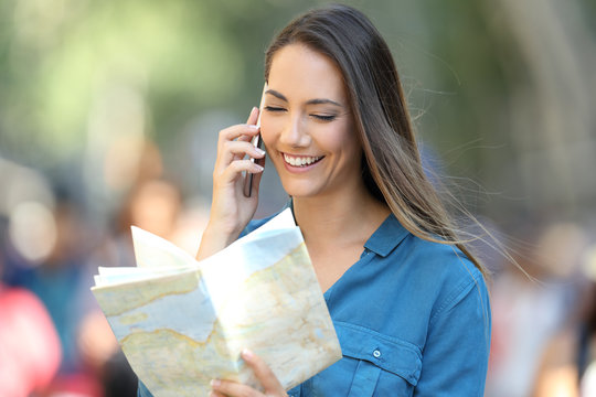Happy tourist asking information on phone