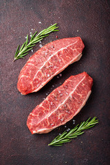 Raw fresh meat Top Blade steaks on dark background. top view
