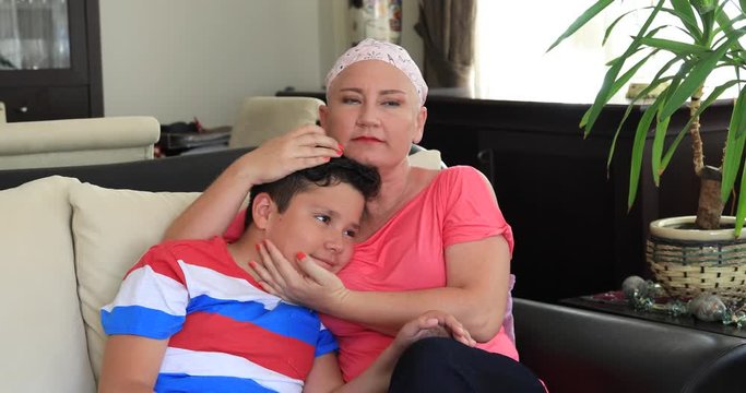 Young boy gives support his sick mother