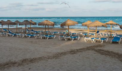 Beach straw umbrella on the blue sea