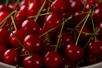 Fresh cherry on a plate with summer flowers. fresh ripe berries. cherries. Close-up