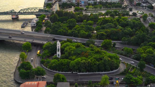 Phra Phuttha Yodfa Bridge, Memorial Bridge in transportation concept. The roundabout with forest trees in Bangkok City, Thailand. 4K cityscape VDO