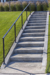 Concrete stairs in community area with lawn