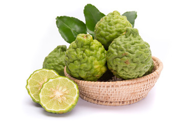 The kaffir lime leaves in the basket on a white background.
