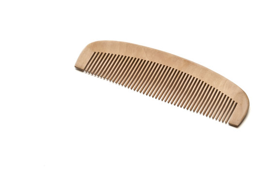 closeup brown wooden comb on a white background