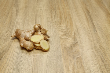 Ginger root sliced on wooden table