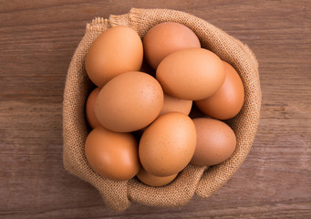 Fresh farm eggs on a wooden rustic background, Whipping eggs and whisk,top view with copy space