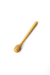 Honey dripping from a wooden honey dipper