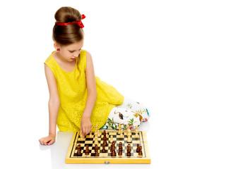 Little girl playing chess