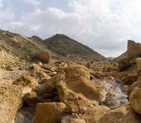Fototapeta premium Beautiful landscape of dried salty mountain river with clouds in the sky at La Rambla, La Murada, Orihuela, Spain Mountain area with small river extremely dry and salty. the water created a unique 