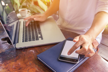 Hand on laptop.