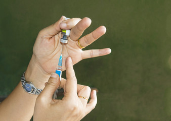 Doctor giving patient vaccine, flu or influenza shot or taking blood test with needle. Nurse with...