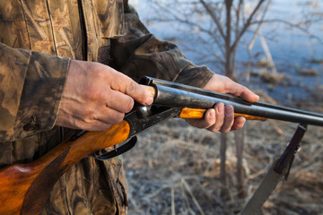 Fototapeta premium Hunter loading a double-barreled gun