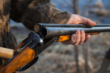 Hunter loading a double-barreled gun