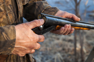 Hunter loading a double-barreled gun