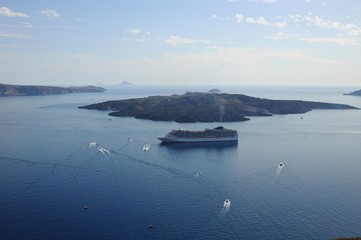 The sailing ships on Aegean sea near the port of Thira in Santorini island, Greece