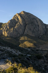 Mountain pico del agudo  La Murada Orihuela, Spain Mountain landscape with path. Hiking and healthy life.natural landscape of the Spanish Levante with vgetation and arid land sunrise light in spring