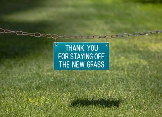 Thank you for staying off the new grass sign