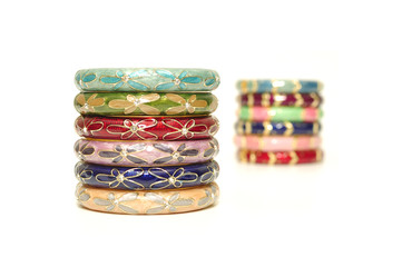 Stack of gold bangle with vivid color and rhinestone isolated on white background