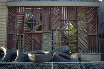 Tires discarded with vines and wood