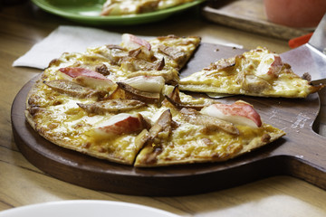 pizza slice on wooden table at shop