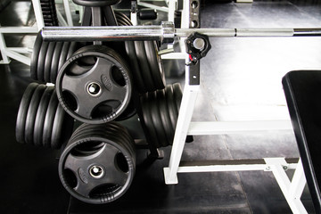 Close up of barbell with weight plates in the gym