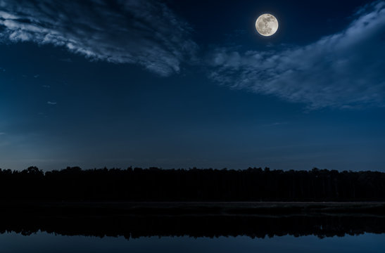 Blue sky and full moon at seaboard. Serenity nature background.