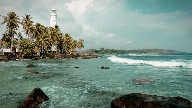 Dondra lighthouse - the southern point of the Sri Lanka island washed by the Indian ocean waves.