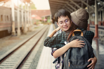 Couple traveller hug for good bye at train station with a traveler.