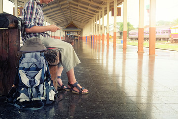 Obraz na płótnie Canvas Backpack and man at the train station with a traveler. Travel concept.