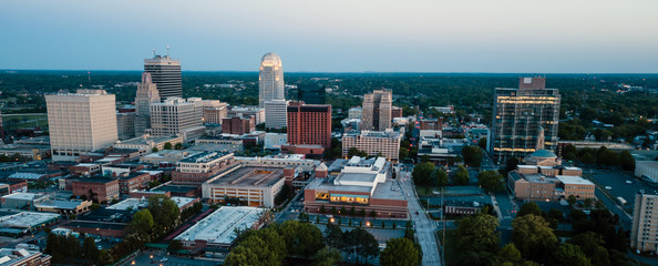 Fototapeta na wymiar Aerial View as Night Falls on the Downtown City Skyline at Winston-Salem
